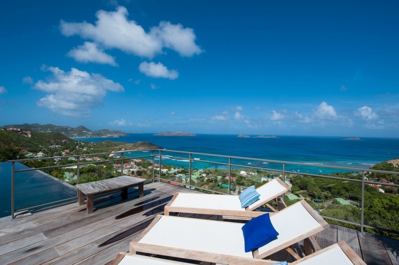 View of the pool terrace with white sunloungers and infinity