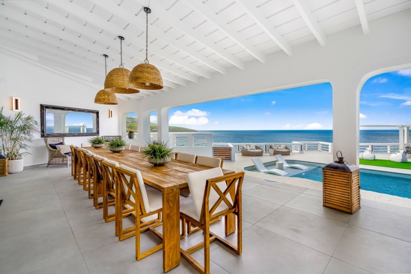 Outdoor dining area by the pool at La Villa Salle