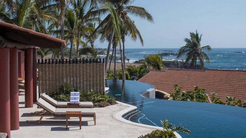 View of the outdoor pool area and infinity pool overlooking 