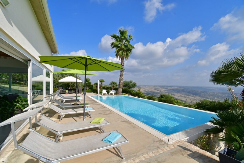 View of the pool and terrace overlooking the hills at villa 