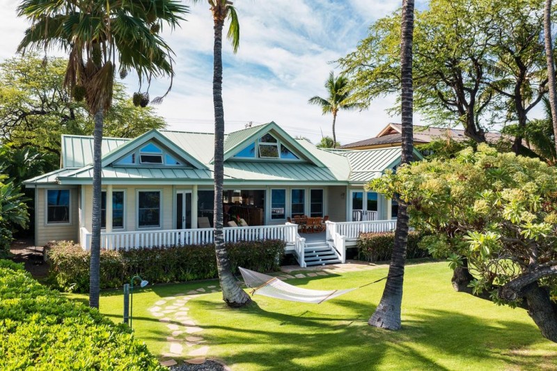 View of the villa's lush garden, hammock and classic exterio