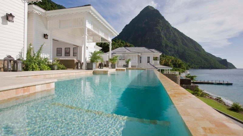 View of the Piton St Luca. Pool and a white house looking on