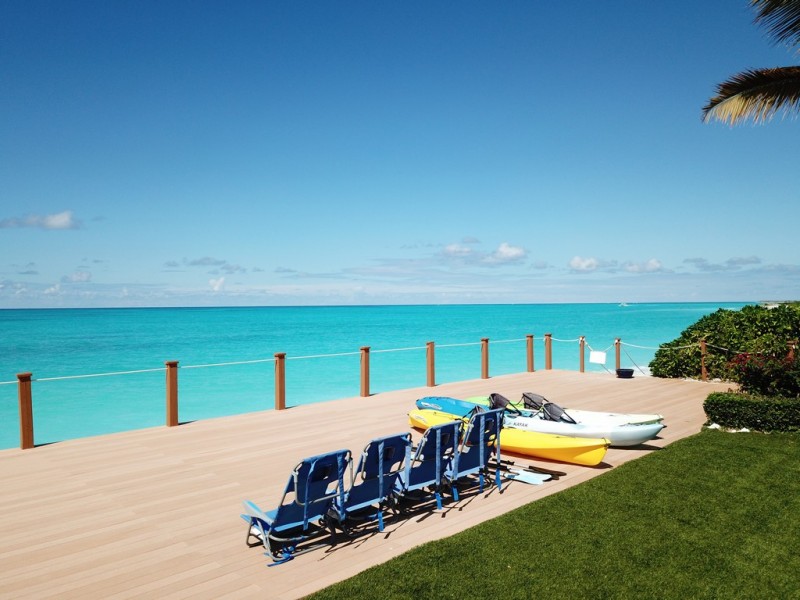 Beach deck with loungers and kayaks at Sunsara in Turks