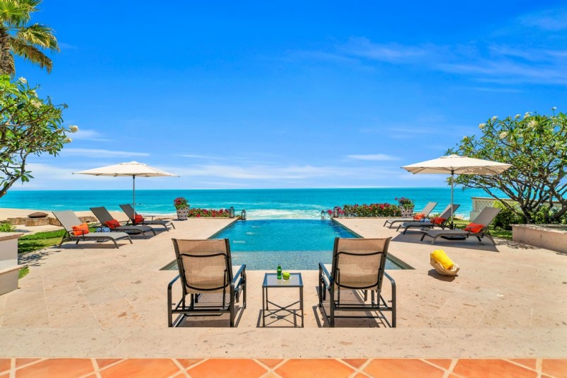 View of the outdoor pool area and infinity pool by the beach