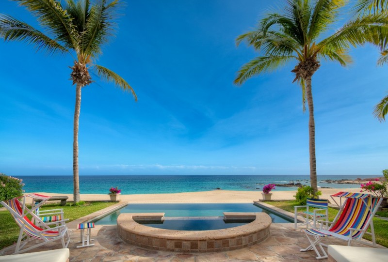 A view of the hot tub and pool, overlooking the beach and th