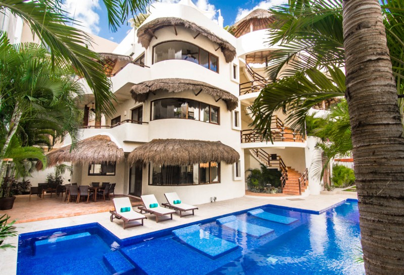 Outdoor pool with sunbeds and a view of the villa