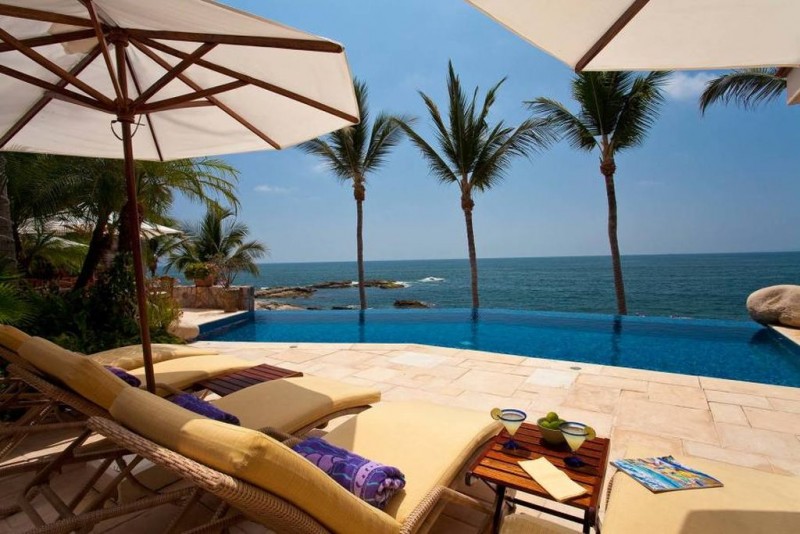 View of villa's pool, palm trees and sea views