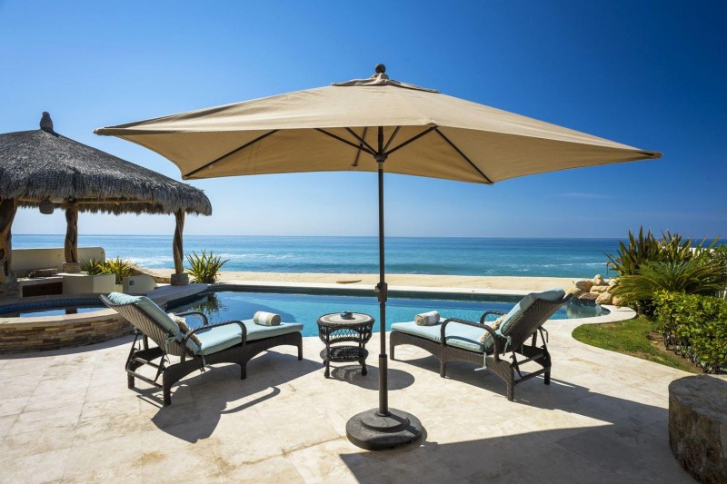 View of the pool and sunbeds, overlooking the sea