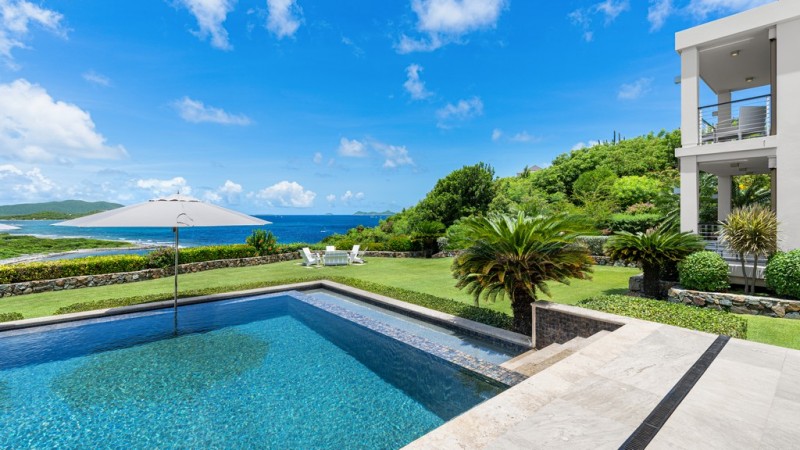 view of villa with sea in the background