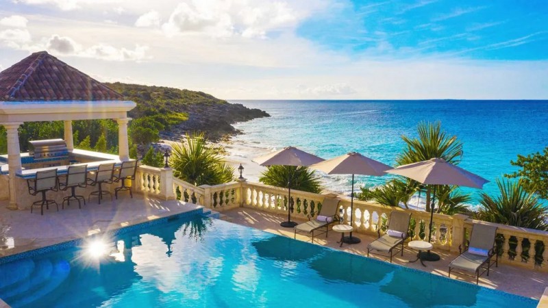 View of Pool with sea in the background