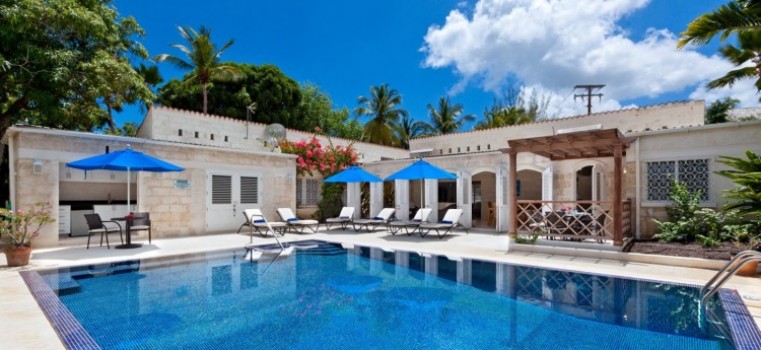 Astonishingly blue pool and parasol covered sunloungers at Todmorden Villa